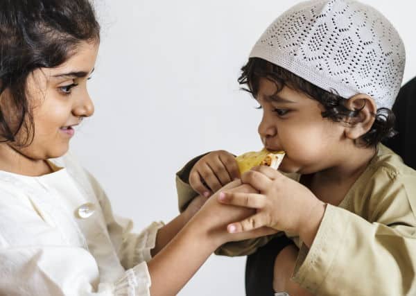 Sister Sharing Bread With Brother